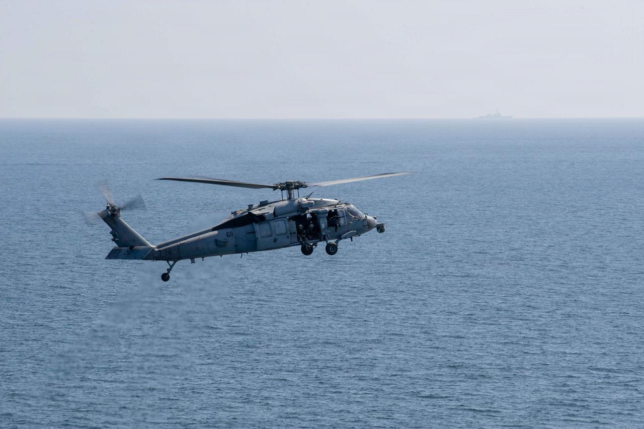An MH-60S Sea Hawk helicopter flies by Nimitz-class aircraft carrier USS Abraham Lincoln (CVN 72) in support of Operation Epic Fury, March 3, 2026. (Photo via U.S. Navy)