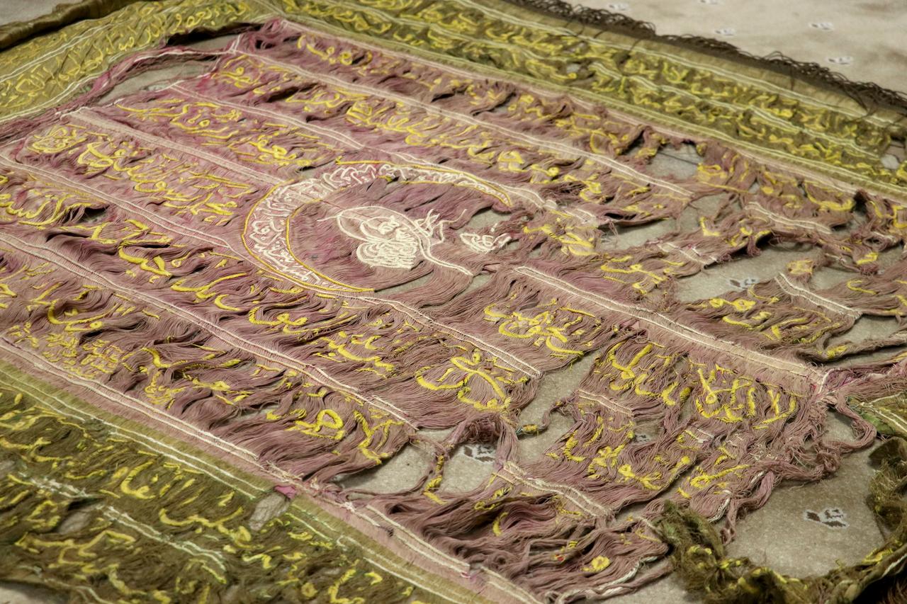 A historic Ottoman-era banner featuring intricate embroidery, religious texts, and the sultan’s tughra shows signs of aging after centuries of preservation in Kayseri, Türkiye. (AA Photo)