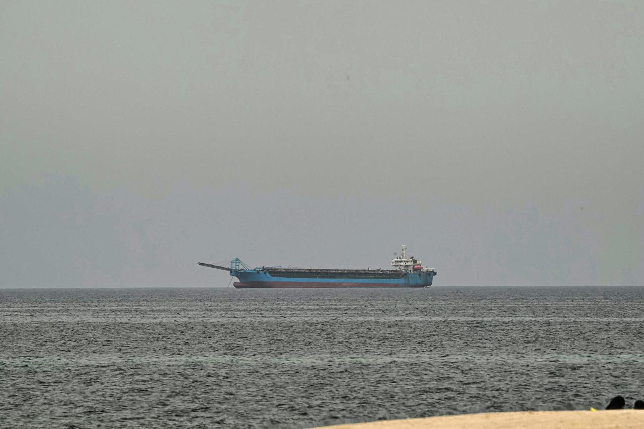 A ship is seen off the coast of Sharjah, the day after the failure of US-Iran peace talks on April 13, 2026. (AFP Photo)