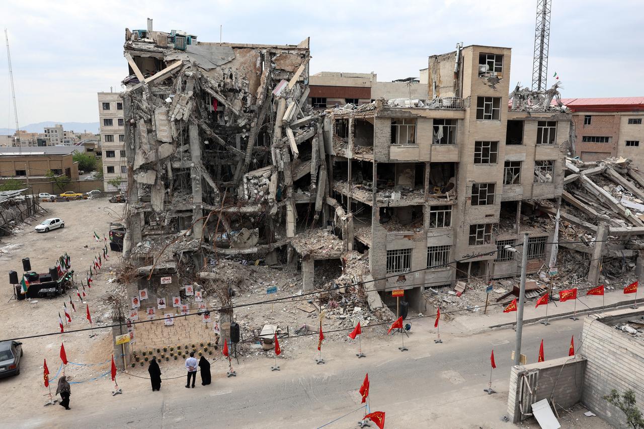Iranians look at portraits of victims reportedly killed in a US-Israeli airstrike on the residential building near which they are displayed, in Tehran, Iran on April 13, 2026. (AFP Photo)