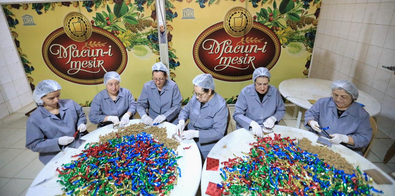 Women sit at a workshop table to hand-wrap thousands of individual pieces of the traditional paste for the upcoming festival, Manisa, Türkiye, April 14, 2026. (AA Photo)