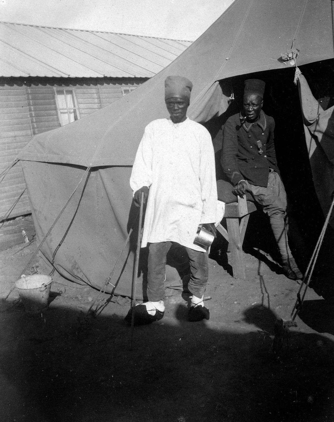 Two Senegalese soldiers serving in the French army stand outside a tent on the island of Lemnos during the Gallipoli Campaign, 1915. (Photo via Little Gully Publishing)