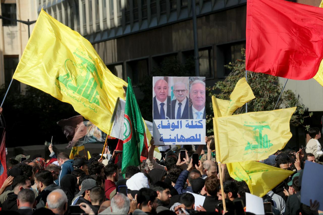 Hezbollah supporters hold up a placard showing the images of the (from left) Lebanese President Michel Aoun, Prime Minister Nawaf Salam, and US Ambassador to Lebanon Michel Issa, in downtown Beirut, Lebanon on April 11, 2026. (AFP Photo)