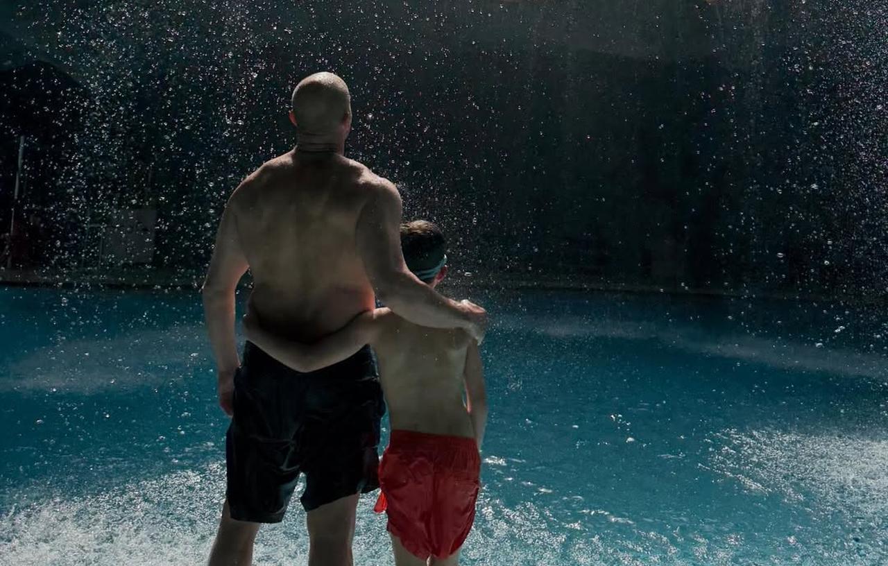 Jason Statham stands with his son under a waterfall inside a cave-themed pool in Antalya, Türkiye, April 15, 2026. (Photo via Instagram/@jasonstatham)