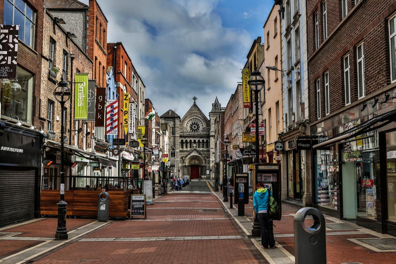 Pedestrianized street featuring local storefronts leading toward St. Ann's Church, Dublin, Ireland, accessed on April 15, 2026. (Adobe Stock Photo)