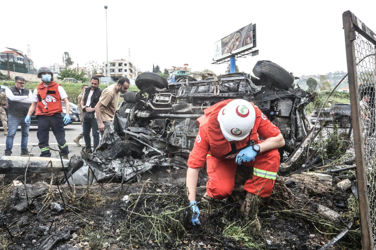 First responders inspect the site of an Israeli airstrike that targeted a vehicle the Lebanese town of Jiyeh, south of Beirut, on April 15, 2026. (AFP Photo)