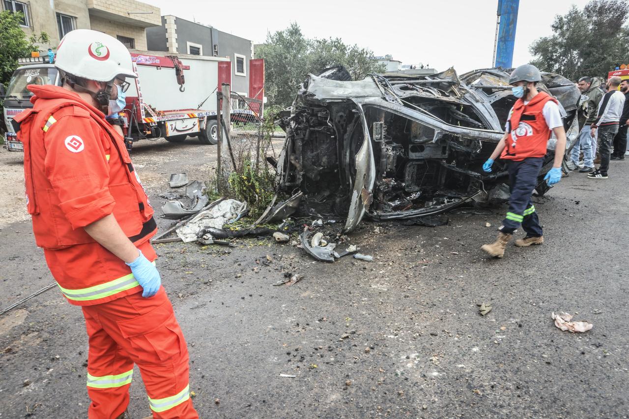 First responders and security forces work at the site of an Israeli airstrike that targeted a vehicle the Lebanese town of Jiyeh, south of Beirut, on April 15, 2026. (AFP Photo)