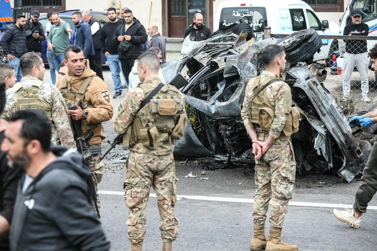 Security forces secure the site of an Israeli airstrike that targeted a vehicle in the Lebanese town of Jiyeh, south of Beirut, on April 15, 2026. (AFP Photo)