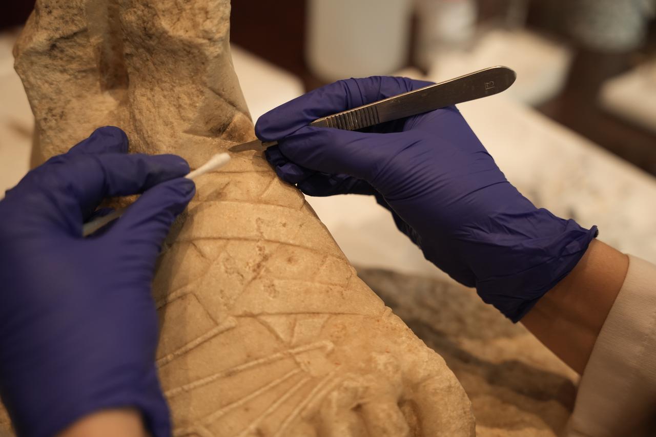 Detailed conservation work is carried out on a sculptural fragment from Troy ahead of its journey to Rome, Canakkale, Türkiye, April 15, 2026. (AA Photo)