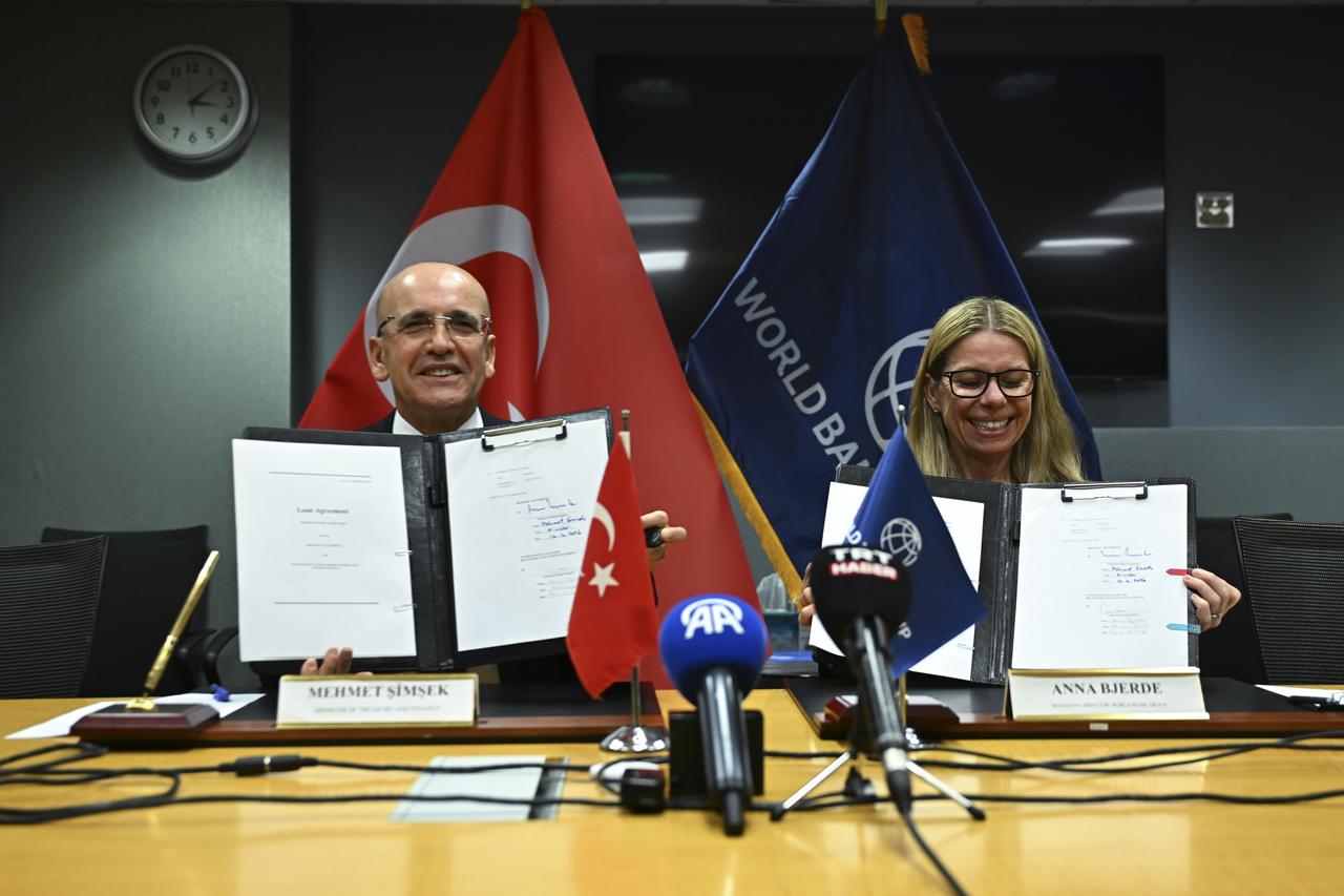 Turkish Treasury and Finance Minister Mehmet Simsek and World Bank's managing director of operations Anna Bjerde pose for a photo during the signing ceremony for the financing agreement held at the World Bank headquarters in Washingon DC, United States, April 14, 2026. (AA Photo)