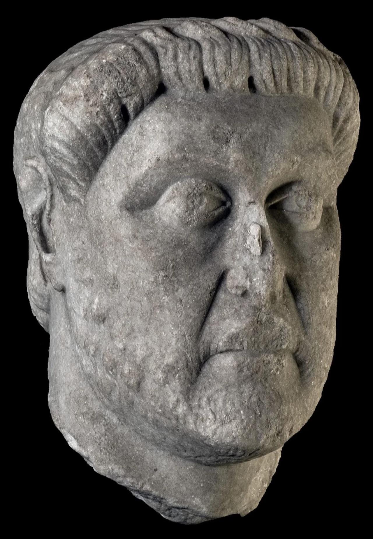 Detail view of the Smyrna-origin marble sculpture head, noted for its stylized hair and expressive facial features, now on display at Izmir Archaeology Museum following its repatriation. (Photo via Dunya Daily)