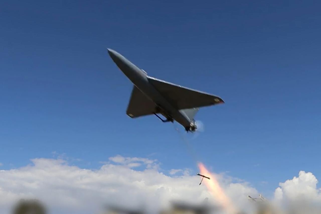 This grab taken from a video on April 6, 2026, shows Iranian drones launched at US targets at Saudi Arabia's Al-Kharj base and Kuwait's Al-Adiri base. (Photo by IRIB News Agency/AFP)