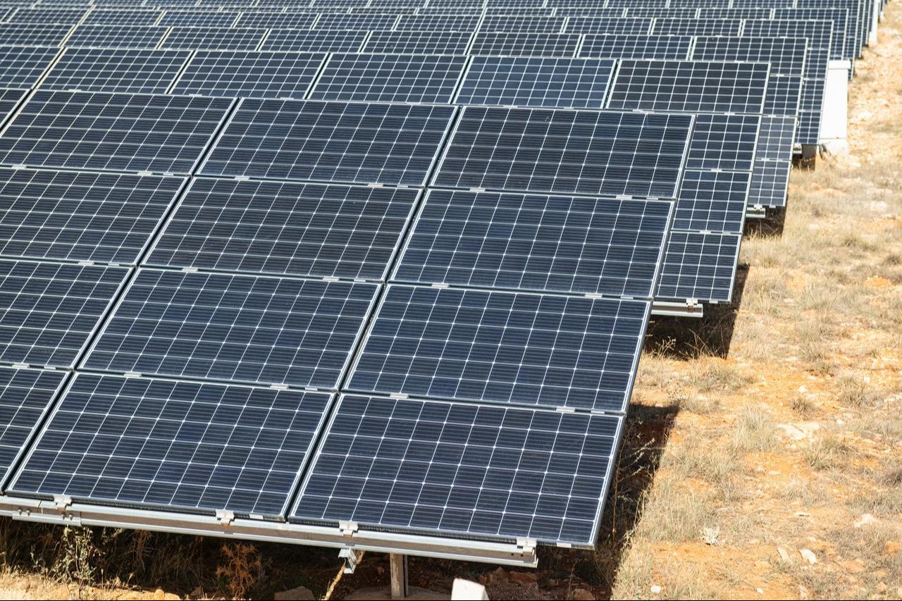 Rows of photovoltaic solar panels generate renewable electricity at a ground-mounted solar installation. (Adobe Stock Photo)