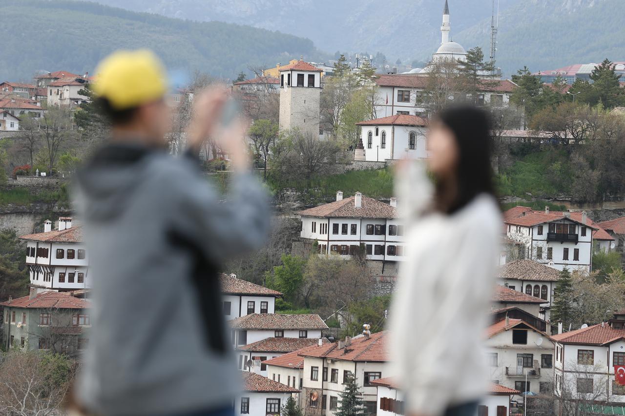 Asian tourists take photos overlooking Safranbolu’s historic Ottoman-era houses in Karabuk, Türkiye, April 2026. (AA Photo)