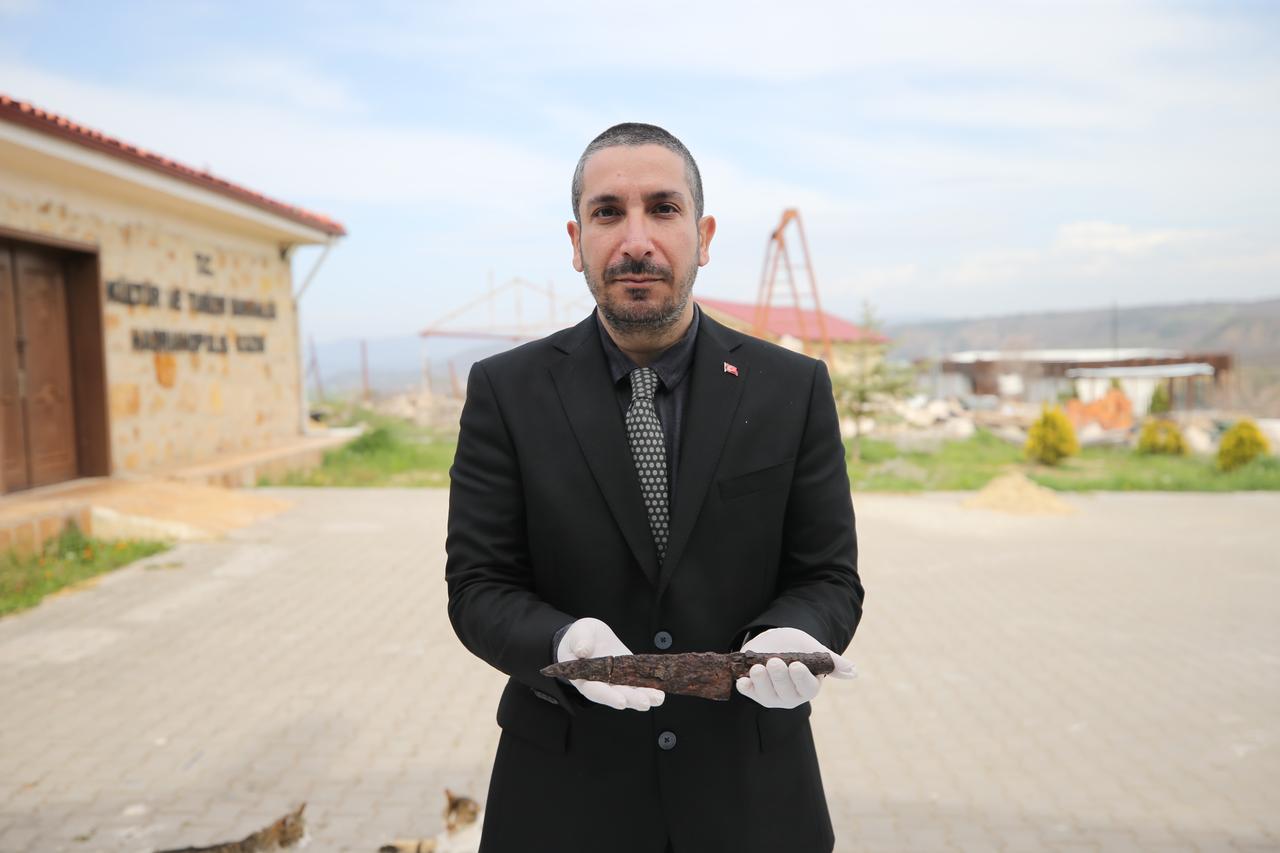 Professor Ersin Celikbas displays a restored 1,500-year-old knife uncovered during excavations at the ancient city of Hadrianopolis in Karabuk, Türkiye, April 17, 2026. (AA Photo)