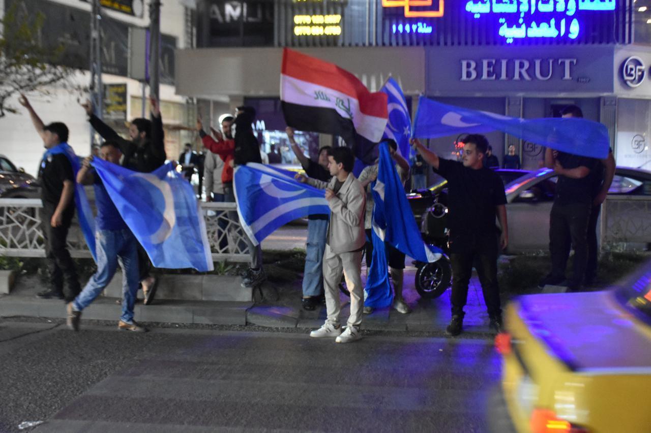 People celebrate carrying the Iraq Turkmen Front and Turkmeneli flags after Muhammed Seman Agha was elected governor of Kirkuk on April 16, 2026. (AA Photo)