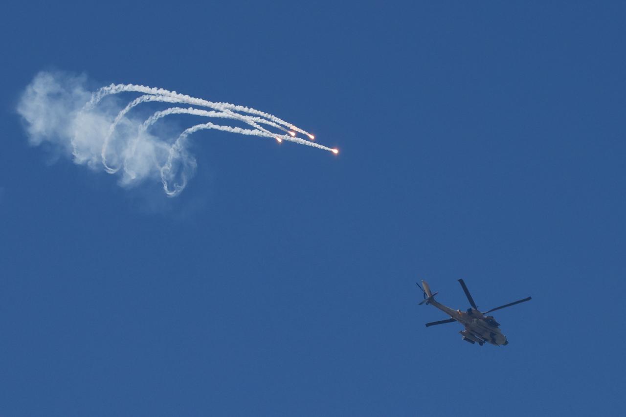 An Israeli Air Force AH-64 Apache attack helicopter fires flares while flying along the border between northern Israel and southern Lebanon on April 12, 2026. (AFP Photo)