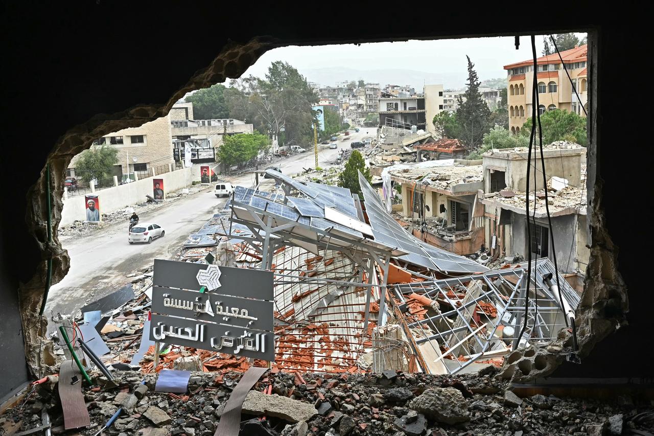 Displaced residents drive past destroyed buildings as they return back to the southern Lebanese city of Nabatieh on April 18, 2026. (AFP Photo)