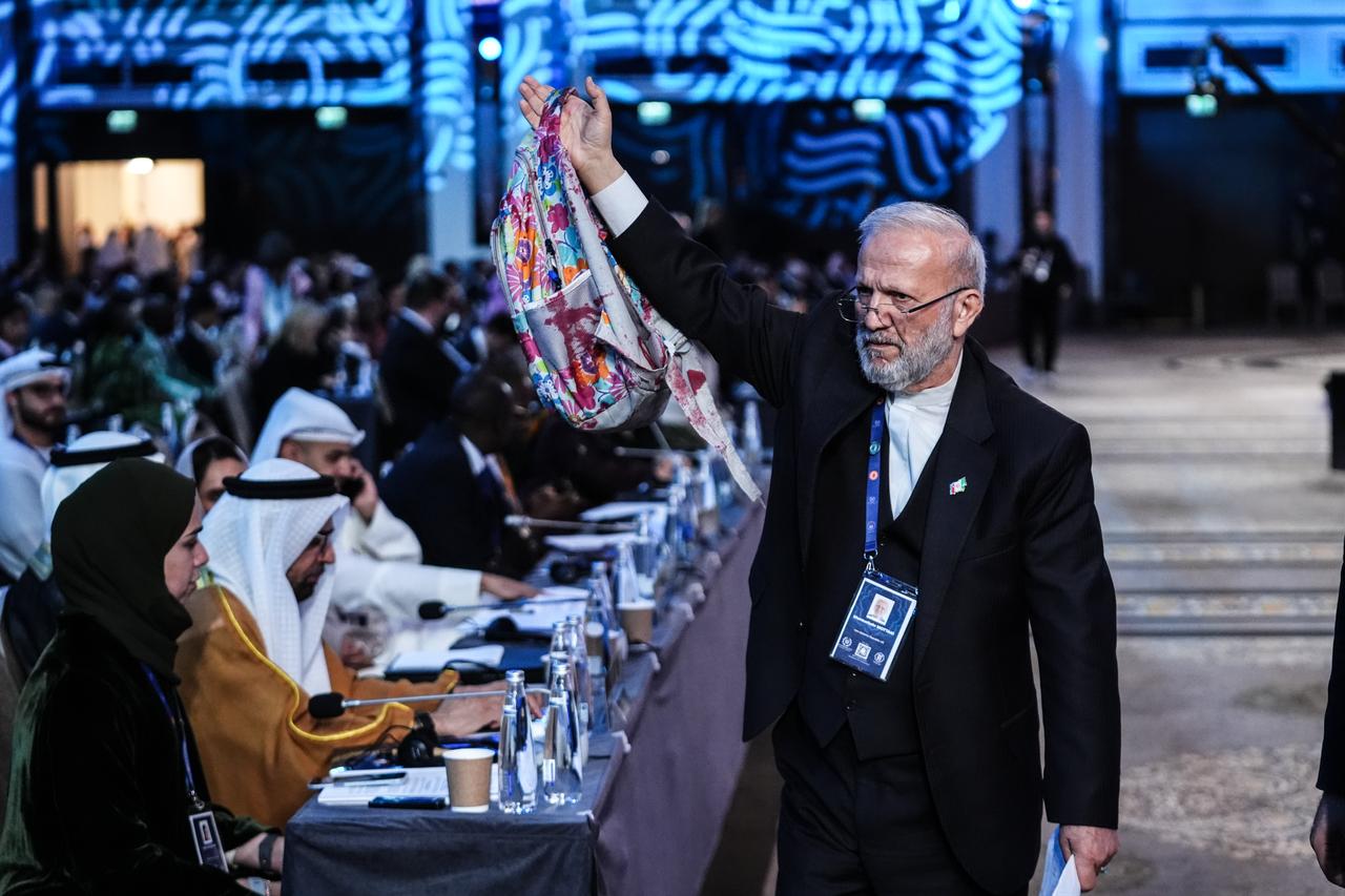An Iranian parliamentarian brings a blood-stained school backpack belonging to a student killed in a school attack in Iran, at a session during the 152nd General Assembly of IPU, April 17, 2026, in Istanbul, Türkiye. (AA Photo)