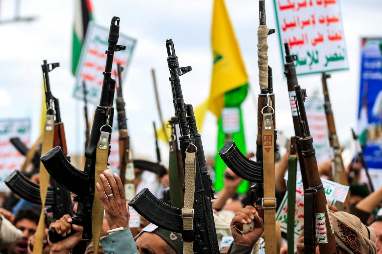 Supporters of the Iran-backed Houthi movement brandish their weapons, banners, and flags in the Yemeni capital Sanaa, April 17, 2026. (AFP Photo)