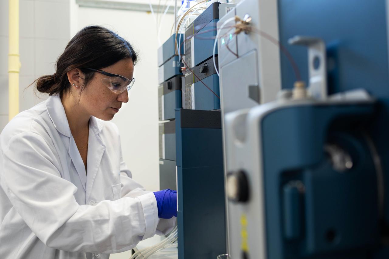 A scientist works with laboratory equipment during a research process at a laboratory, date unknown. (Adobe Stock Photo)