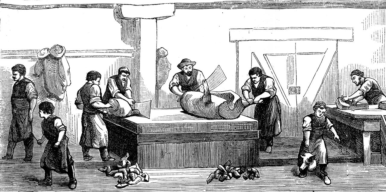 Workers process meat in a factory setting in an unspecified location, undated. (Adobe Stock Photo)