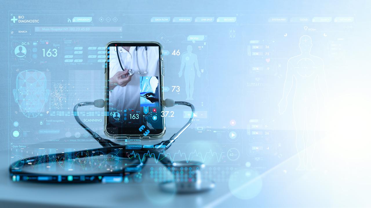 A smartphone displays a doctor and digital health data interface with a stethoscope in the foreground (Adobe Stock Photo)