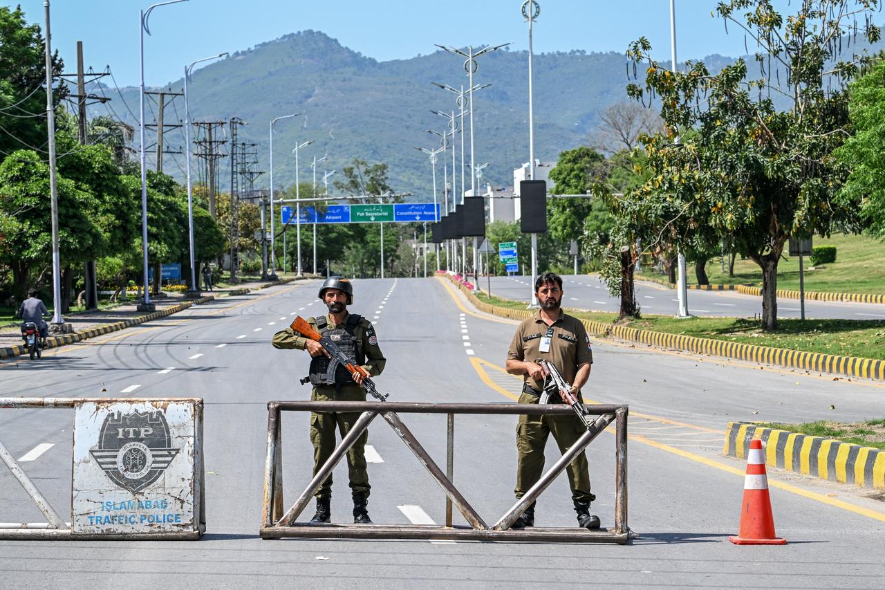 Police personnel stand guard at a closed road leading to the Serena Hotel in the Red Zone area of Islamabad on April 19, 2026. (AFP Photo)