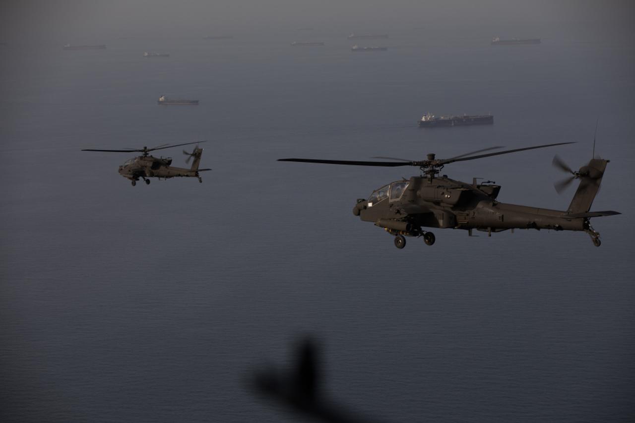 US Army AH-64 Apaches fly above the Strait of Hormuz during a patrol, on April 17, 2026. (Photo via X/@CENTCOM)