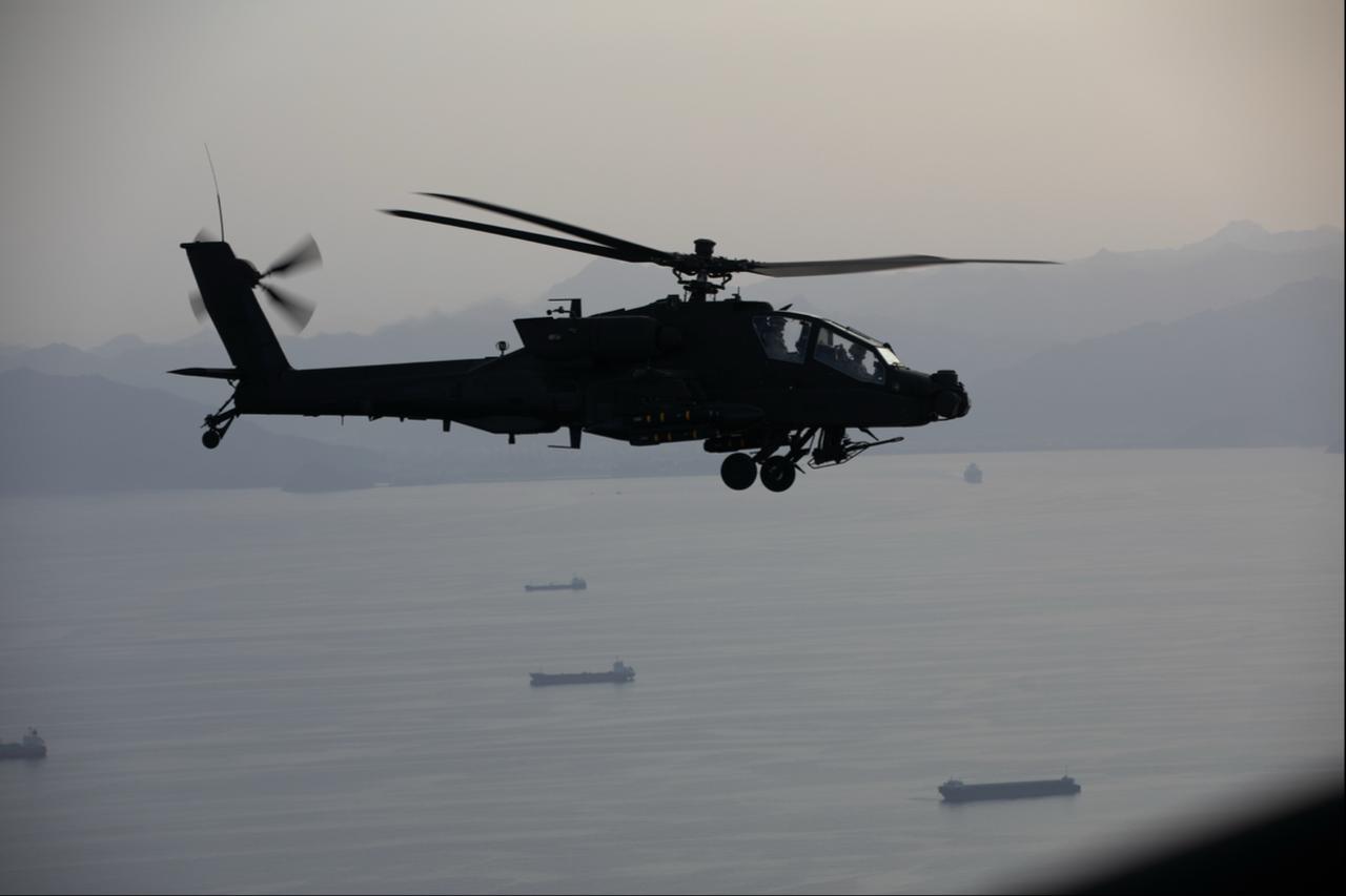 US Army AH-64 Apaches fly above the Strait of Hormuz during a patrol, on April 17, 2026. (Photo via X/@CENTCOM)