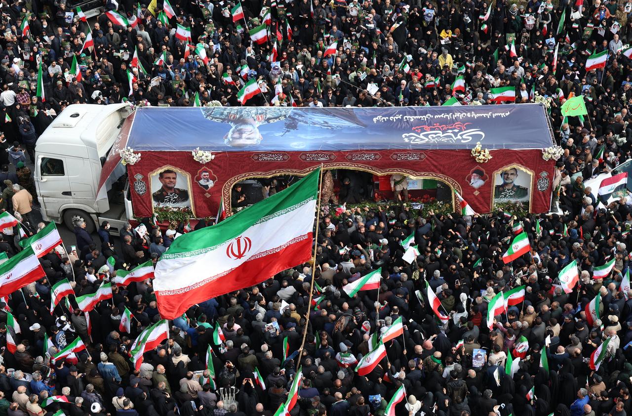 People wave Iranian flags at the funeral of Alireza Tangsiri, commander of the Iranian Revolutionary Guard's navy, at Enghelab Square in Tehran, April 1, 2026. (AFP Photo)