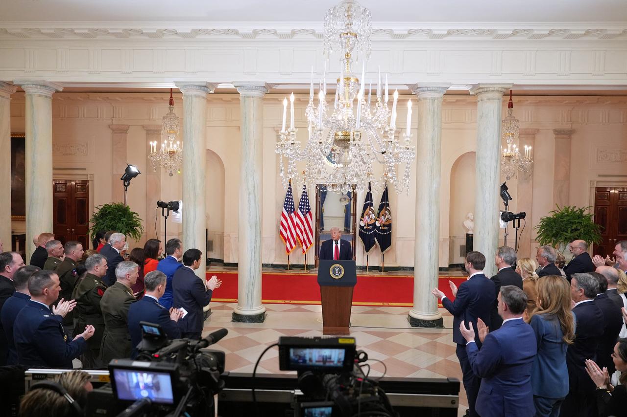Guests applaud as US President Donald Trump concludes his televised address on the conflict in the Middle East from the Cross Hall of the White House in Washington, DC on April 1, 2026. (AFP Photo)