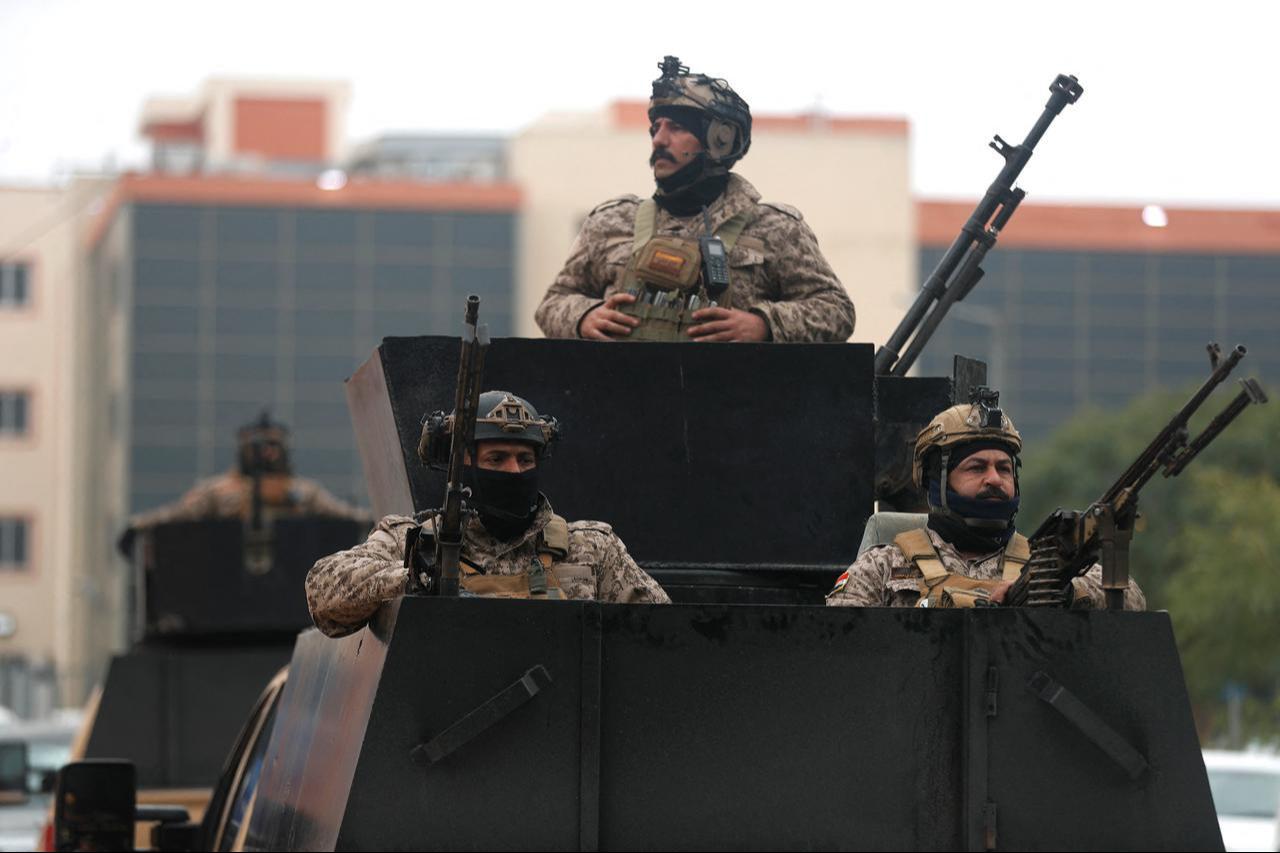Iraqi soldiers guard the entrance to Fallujah Hospital in Fallujah, west of Baghdad, on March 26, 2026. (AFP Photo)
