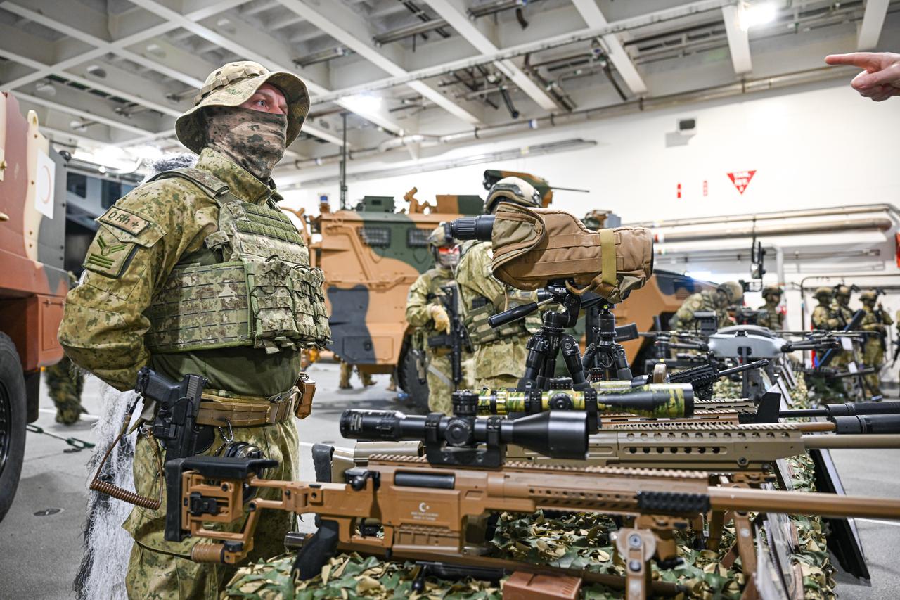 Turkish soldiers stand guard alongside military vehicles and unmanned aerial systems aboard the Turkish naval vessel TCG Anadolu, docked in Rotterdam, South Holland, Feb. 27, 2026. (AA Photo)