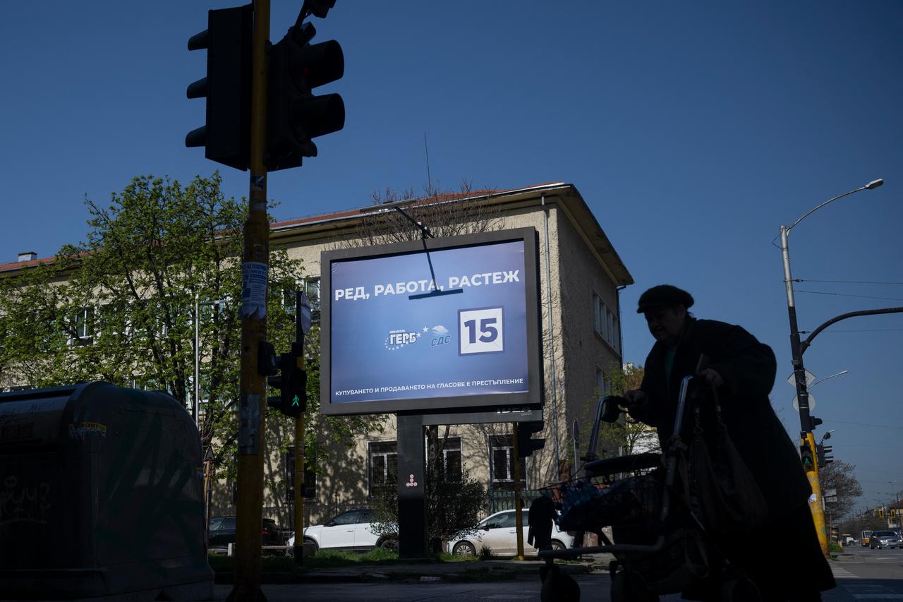 Pedestrians walk past an electoral billboard of the GERB party in Sofia on April 17, 2026. (AFP Photo)