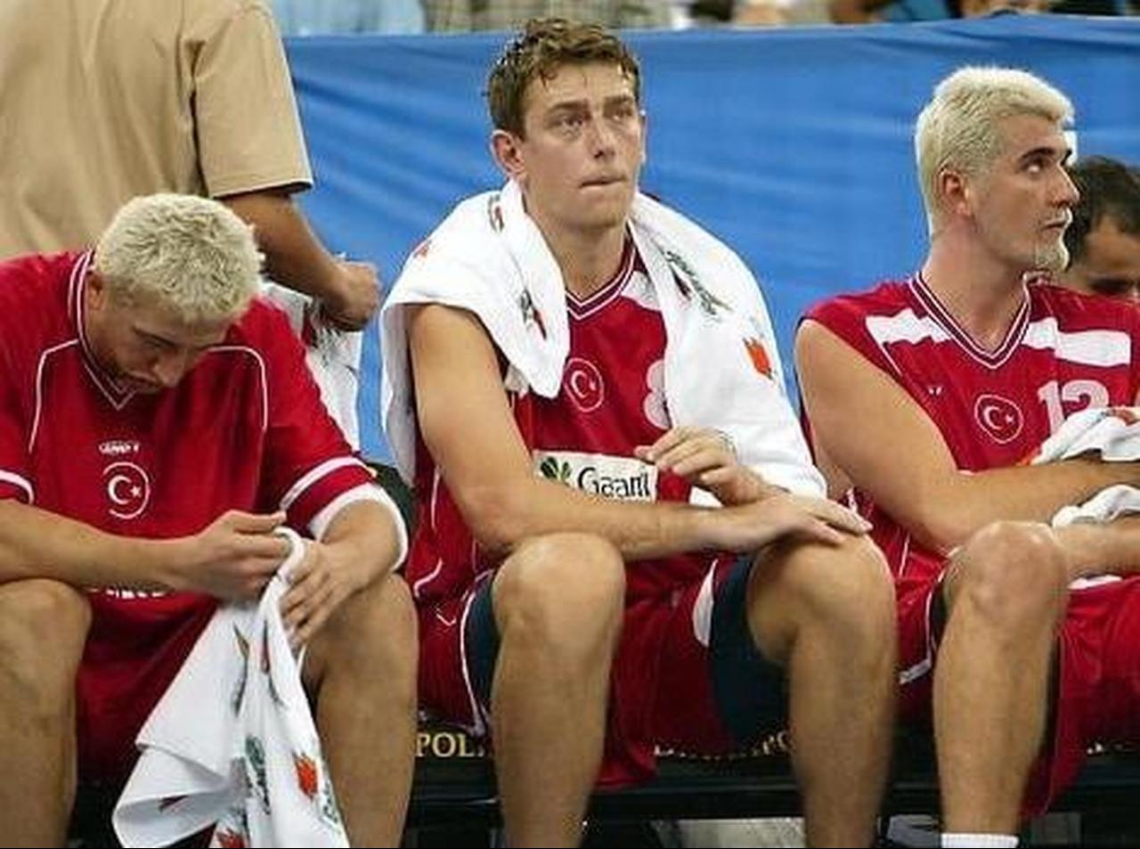 Hidayet Turkoglu (L) Asim Pars (C) and Huseyin Besok (R) sit on the bench 29 August, 2002 during their loss to Puerto Rico in preliminary round one of the 2002 Men's FIBA World Basketball Championships at the RCA Dome in Indianapolis, United States. (Getty Images)