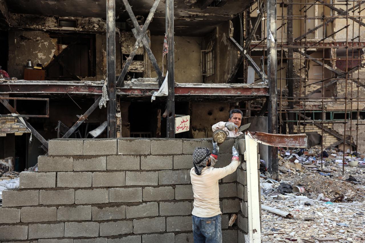 Workers build up a structure in front of a residential building hit by US-Israel airstrikes at the Shahid Broujerdi residential complex in southern Tehran, Iran on April 14, 2026. (AFP Photo)