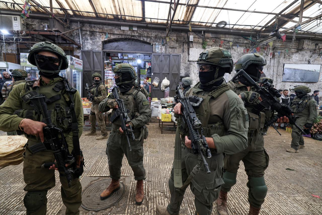 Israeli soldiers patrol the market in the Old City of Nablus, in the northern Israeli-occupied West Bank on April 12, 2026. (AFP Photo)