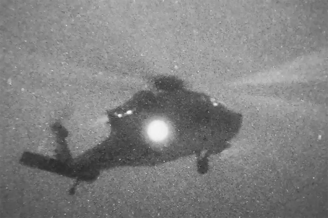 This screen grab obtained from a video released on April 20, 2026, shows a US Marine Corps helicopter departing from the amphibious assault ship USS Tripoli in the Arabian Sea to board and seize the Iranian-flagged vessel M/V Touska. (Photo by US Central Command Public Affairs/AFP)