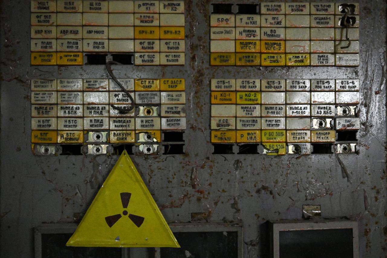 This photograph taken on April 9, 2026, shows a radioactivity sign on a panel in the control room of the destroyed 4th block of the Chornobyl Nuclear Power Plant, amid the Russian invasion of Ukraine. (AFP Photo)