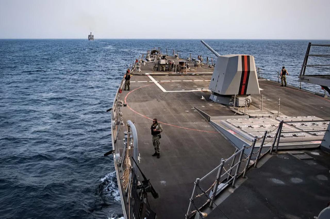 Sailors stand watch on the forecastle of the guided-missile destroyer USS Jason Dunham as the ship escorts the fleet replenishment oiler USNS Laramie (rear) transiting the Bab al-Mandeb strait. (US Navy/AFP Photo)