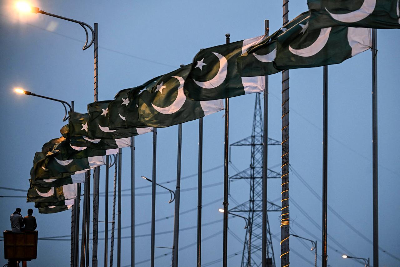 Capital Development Authority (CDA) workers set up Pakistan's national flags along a street in Islamabad, Pakistan on April 18, 2026. (AFP Photo)