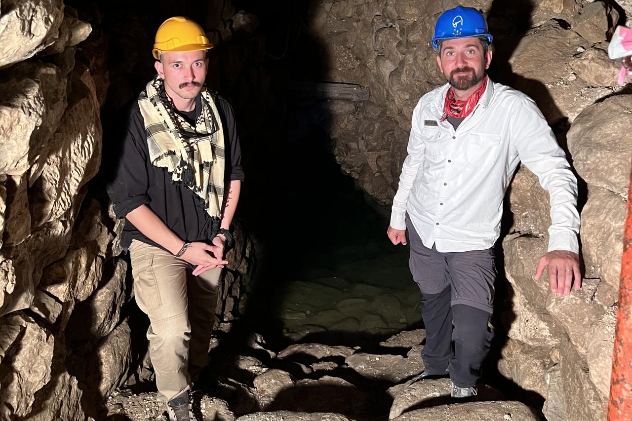 Koray Erdogan (L) and Assoc. Prof. Mehmet Ali Yilmaz (R) stand inside the underground tunnel leading to the sacred Hittite spring at Oymaagac Hoyuk in Samsun, Türkiye. (Photo by Türkiye Today team)