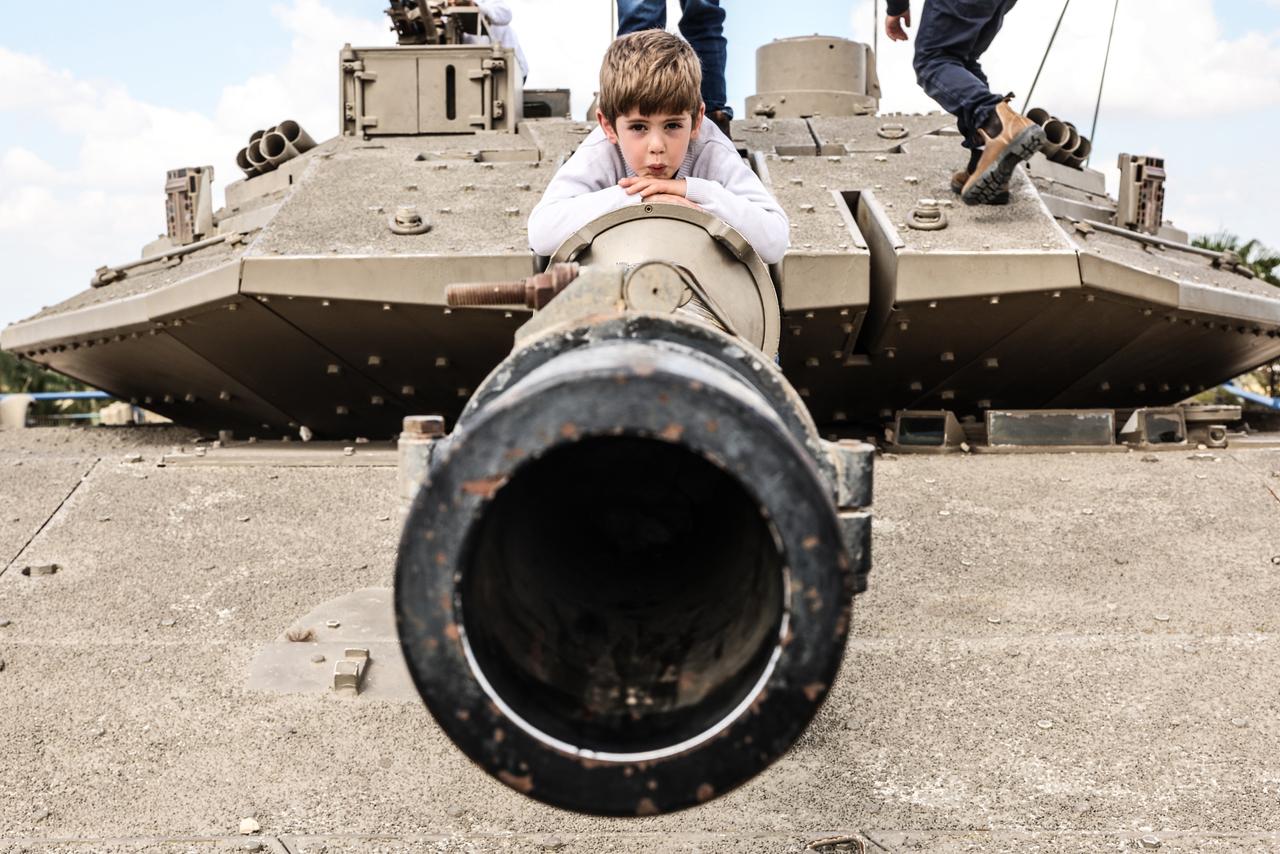 A child climbs atop old tanks and military vehicles at the Israeli Armoured Corps memorial in Latrun, between Jerusalem and Tel Aviv, April 21, 2026. (AFP Photo)
