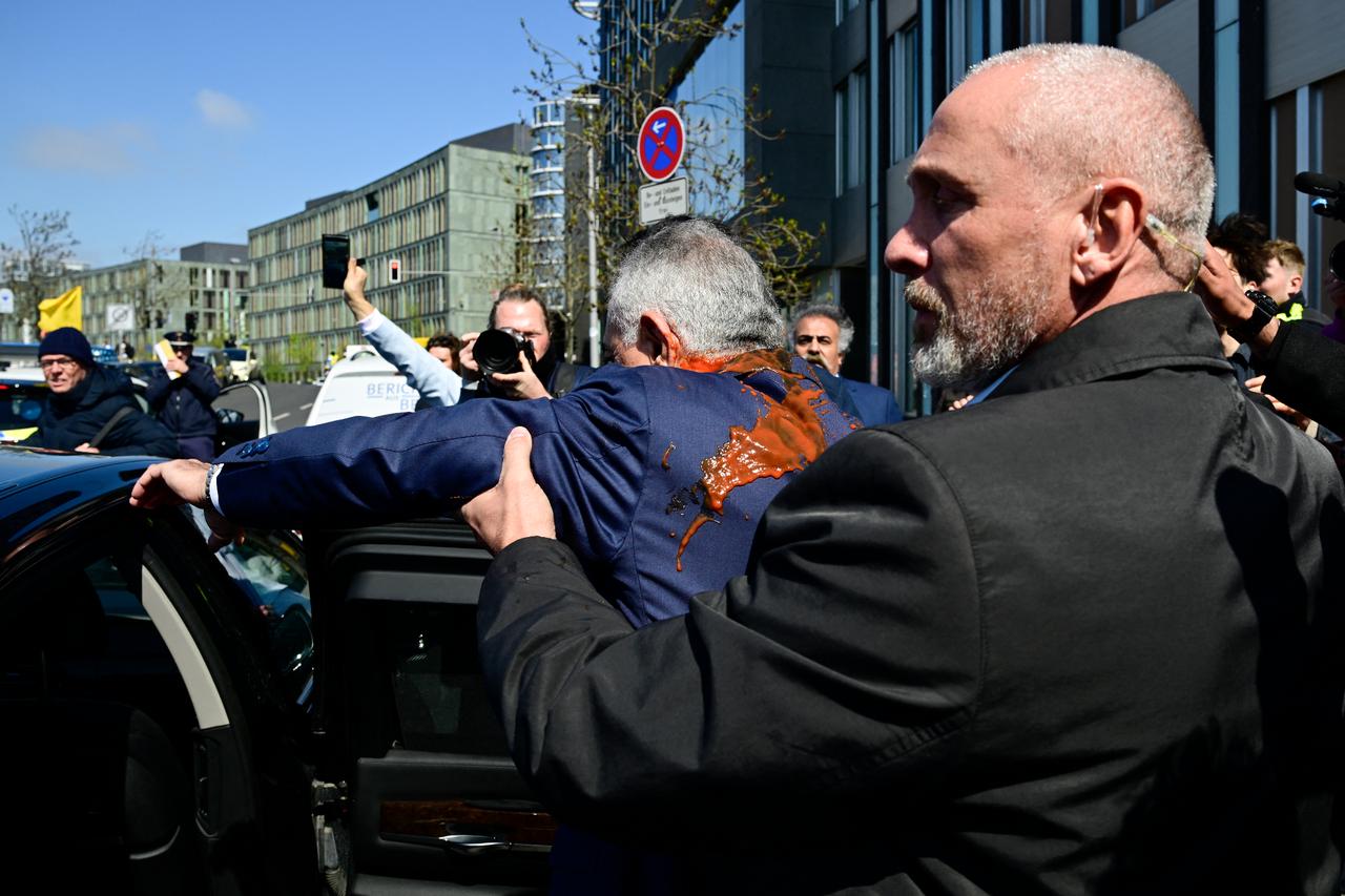 Iran’s exiled crown prince Reza Pahlavi splashed with red liquid in Berlin