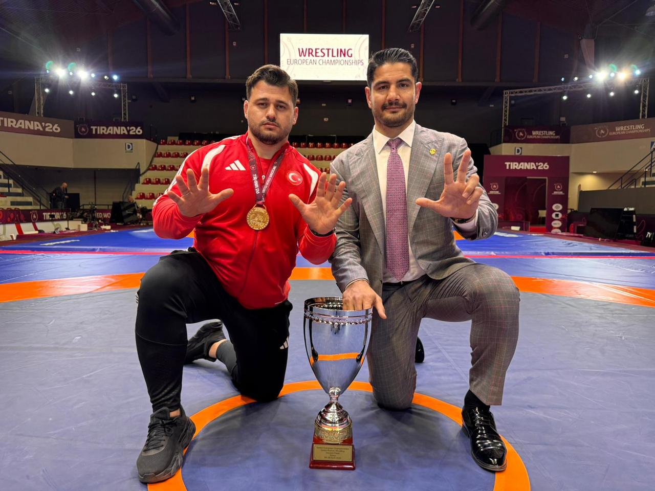 Turkish Wrestling Federation President Taha Akgul (right) and Riza Kayaalp, who became European champion for the 13th time, posed with the trophy. Albania, April 22, 2026. (AA Photo)