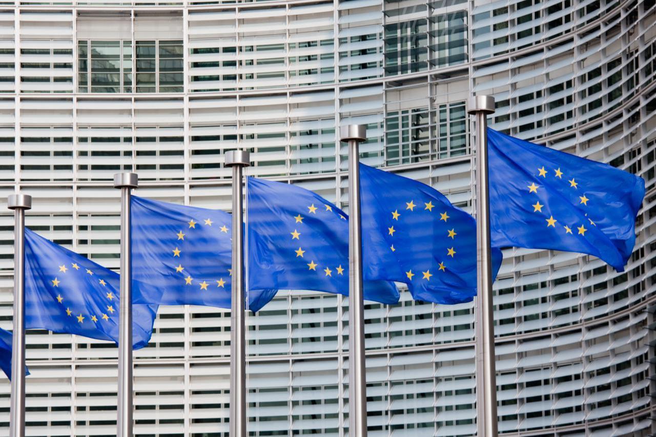 A line of EU flags stands in front of the European Commission building in Brussels. (Adobe Stock Photo)
