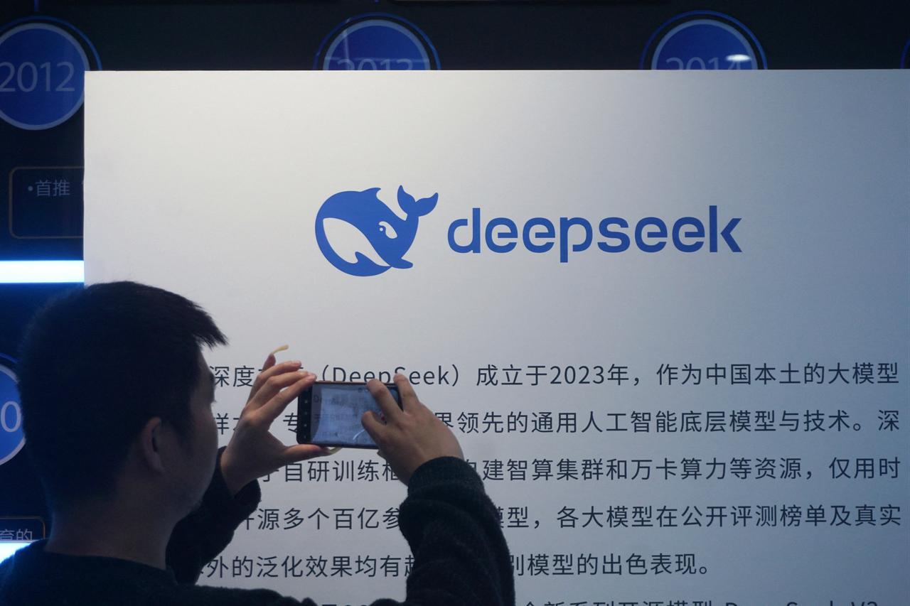 A man takes photos of a DeepSeek display at a shopping mall in Hangzhou, Zhejiang province, China, April 23, 2026. (AFP Photo)