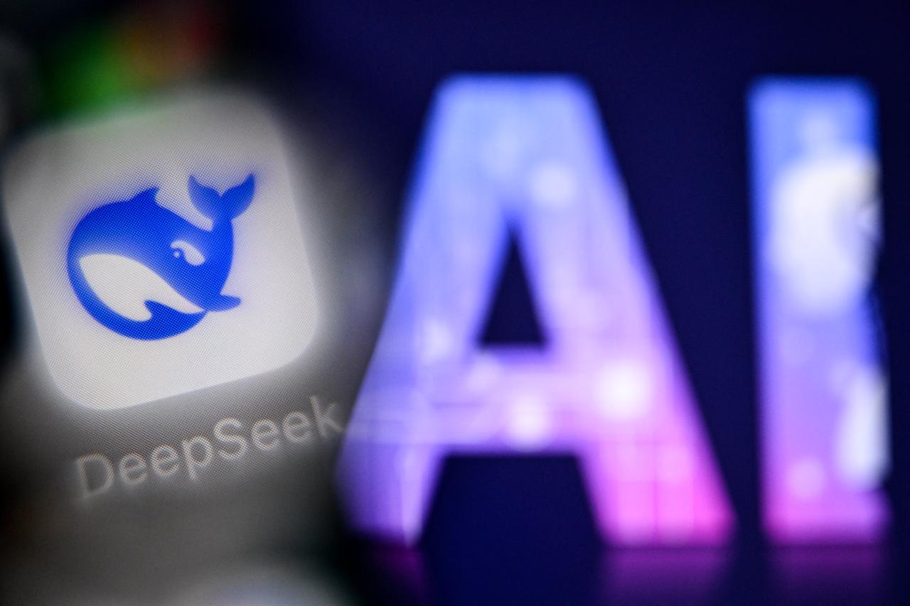 The DeepSeek AI application logo is displayed on a smartphone screen beside the letters “AI” on a laptop screen in Frankfurt am Main, Germany, Sept. 1, 2025. (AFP Photo)