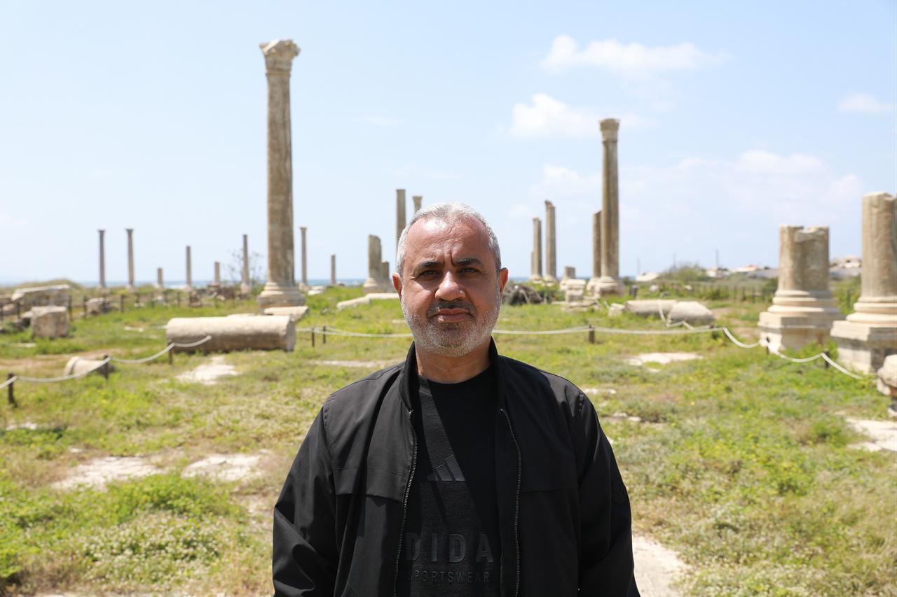 A local official, Tyre Deputy Mayor Alvan Serefuddin, stands among ancient columns at the archaeological site in Tyre, southern Lebanon, where historical structures were affected by nearby Israeli strikes, April 24, 2026. (AA Photo)